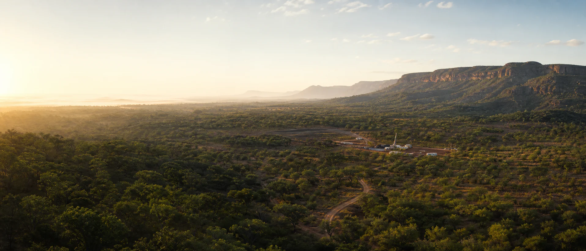 Copperbelt landscape at dawn with a mineral exploration camp in the distance