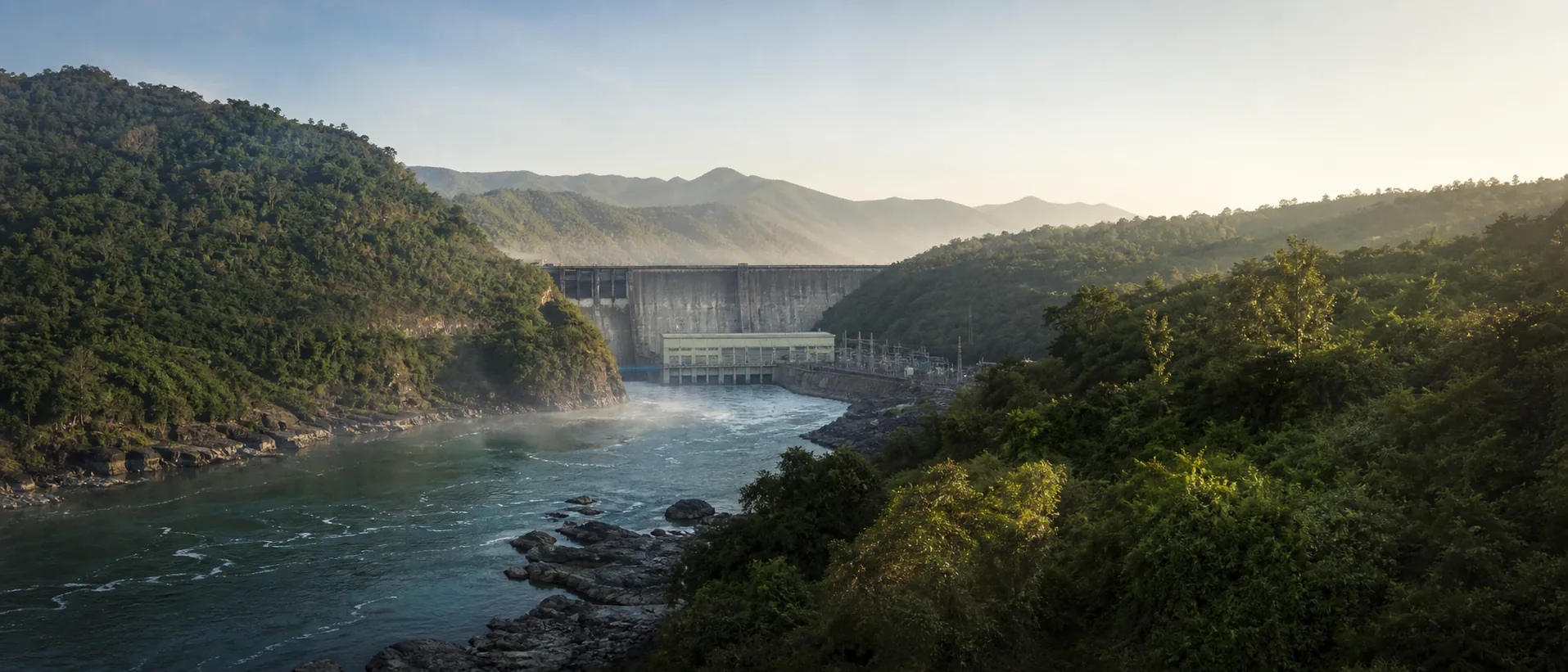 Hydroelectric power facility in a green river valley